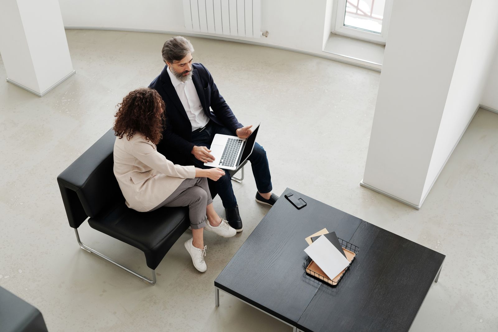 Two business professionals in conversation in a modern office